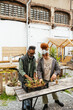 © BONNINSTUDIO/Stocksy - Volunteers working in an urban organic Community Garden