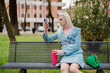 © Mauro Grigollo/Stocksy - A non-binary man sitting on a bench at the city park