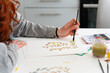 © Luis Velasco/Stocksy - Anonymous Woman Painting A Illustration At Home.