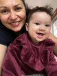 © Olga Moreira/Stocksy - User-generated content: mother with daughter smiling at camera