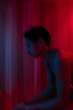 © Rob and Julia Campbell/Stocksy - Blurry silhouette in red sauna light