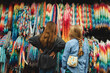 © Julia W/Stocksy - Boy and girl standing in front of a collection of paper cranes
