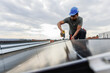 © Jovo Jovanovic/Stocksy - Male technician installing solar panels on rooftop