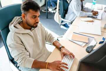 A man uses a computer in the office