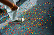 © DZ FILM/Stocksy - A man stands on the floor covered with confetti