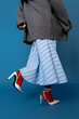 © Tania Cervian/Stocksy - Anonymous stylish model in jacket standing against blue background
