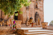 © Heng Yu/Stocksy - Traditional puppets hanging on tree at Bagan temple