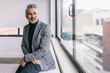 © VICTOR TORRES/Stocksy - Confident businessman in a modern office setting