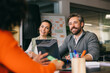 © VICTOR TORRES/Stocksy - Collaborative business team in a casual office meeting