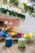 © VICTOR TORRES/Stocksy - A vibrant and modern office lounge with colorful chairs