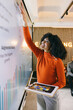 © VICTOR TORRES/Stocksy - Casual businesswoman presenting on an interactive screen