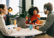 © VICTOR TORRES/Stocksy - Podcast recording session with diverse co-hosts in studio
