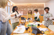 © Guille Faingold/Stocksy - Interactive Team Meeting with Documents