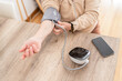 © Alvaro Lavin/Stocksy - Woman checking blood pressure at home.