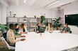 © VICTOR TORRES/Stocksy - Diverse team in a modern office meeting