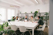 © VICTOR TORRES/Stocksy - Business team engaged in a casual meeting at modern office