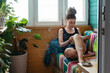 © Irina Polonina/Stocksy - Woman Reading by Window in Sunlit Room