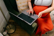 © Lea Jones/Stocksy - close up of pregnant woman on laptop