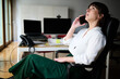 © Guille Faingold/Stocksy - Businesswoman on Phone Call at Desk