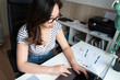 © nomad studio/Stocksy - Young woman working on laptop at home office
