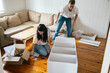 © Pedro Merino/Stocksy - Couple assembling a bookshelf at home
