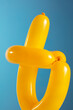 © Pepino de Mar studio/Stocksy - Twisted yellow balloon