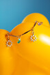 © Pepino de Mar studio/Stocksy - Charm chain on yellow balloon