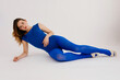 © Tania Cervian/Stocksy - Flexible woman stretching body on floor