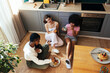 © BONNINSTUDIO/Stocksy - Female roommates having breakfast in kitchen