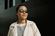 © Azamat Mukanov/Stocksy - Smiling Asian Woman in Sunglasses