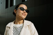 © Azamat Mukanov/Stocksy - Smiling Asian Woman in Sunglasses