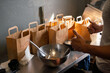 © Hernandez & Sorokina/Stocksy - Prepared Take Away Orders At Restaurant Kitchen Tabletop