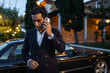 © Lupe Rodríguez/Stocksy - elegant young man in suit jacket using mobile phone