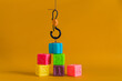 © Julia Potato/Stocksy - Сolorful plastic cubes with numbers lined up move with a hook