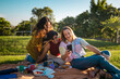 © Pedro Merino/Stocksy - Friends having picnic in Brisbane