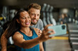 © Lumos sp - gym sport fitness exercise health woman training phone selfie coach trainer instructor personal photo portrait self posing camera healthy boyfriend girlfriend love