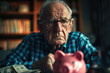 © Andrii Yalanskyi - A sad old man sits near a piggy bank and money. Seniors retirement income and savings concept. Pension