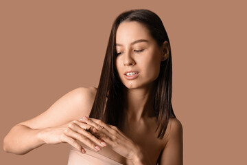 Poster - Young dark-haired woman on beige background