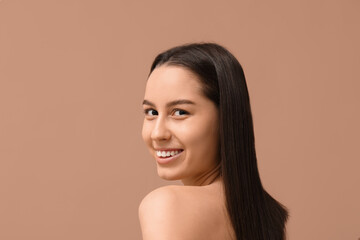 Poster - Young dark-haired woman on beige background