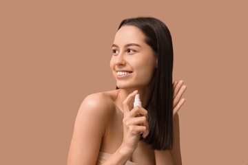 Canvas Print - Young woman with cosmetics for hair treatment on beige background