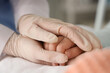 © Pixel-Shot - Little girl after chemotherapy with doctor holding hands in clinic, closeup. International Childhood Cancer Day