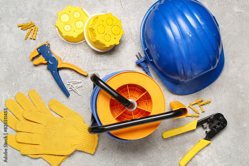Set of electrician equipment on white grunge background