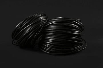 Rolled cables on black background, closeup