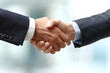 © maxcol79 - Photo of a business man's handshake, hands in a business suit. Close-up with blurred background