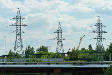 Wall Mural - Power lines running through the forest. The support of an overhead power line. Natural landscape and technological progress.