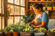 © VisualProduction - Hispanic woman potting plants in her garden shed with sunset light filtering in.