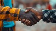 © KHF - A firm handshake between two adult men of different ethnicities outdoors, symbolizing agreement and partnership.