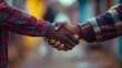 © KHF - A firm handshake between two adult men of different ethnicities outdoors, symbolizing agreement and partnership.