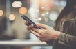 © LU - A close-up of a woman's hand using a mobile phone with a social media icon floating on the screen, a light bokeh background, the concept of online marketing.
