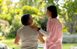 © Wavebreak Media - Asian young female nurse and middle-aged patient outside in casual clothes